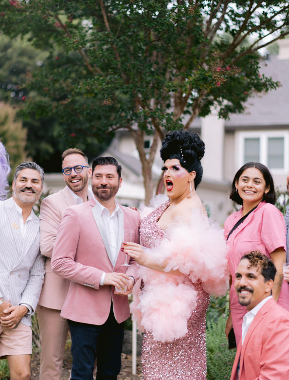 A group of people posing for a picture outside at a Givher event