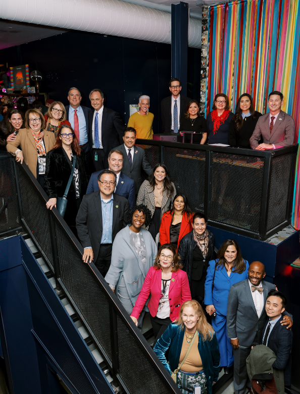 A group of people posing on a stairwell at a Givher event